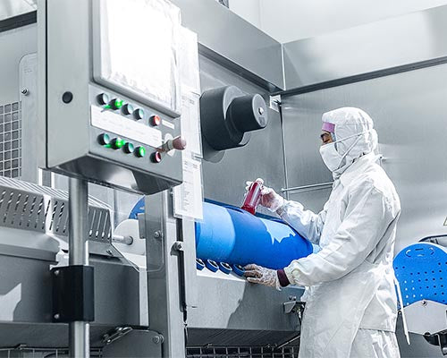 Man taking bottle out of hpp machine
